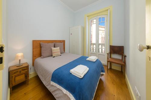 a bedroom with a bed and a chair and a window at Casa Mariana 2 - Sintra, Apartment in Sintra