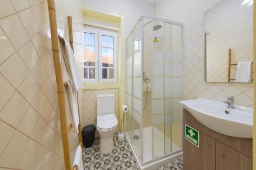 a bathroom with a toilet and a sink and a shower at Casa Mariana 2 - Sintra, Apartment in Sintra