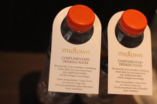 two bottles of molons with labels on them at Midtown Hotel Samarinda in Samarinda