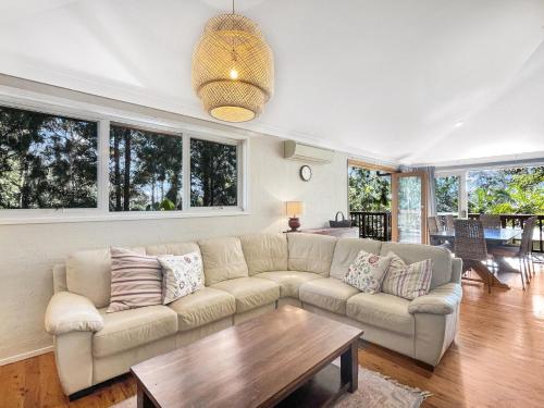 a living room with a couch and a table at Riverside 3-Bed Townhouse with Spacious Deck in Mossy Point