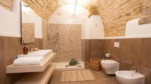 a bathroom with a sink and a toilet and a shower at Roberto Historic House in Gubbio