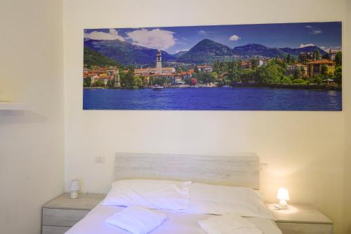 a bedroom with a large painting on the wall at Gigi House in Verbania