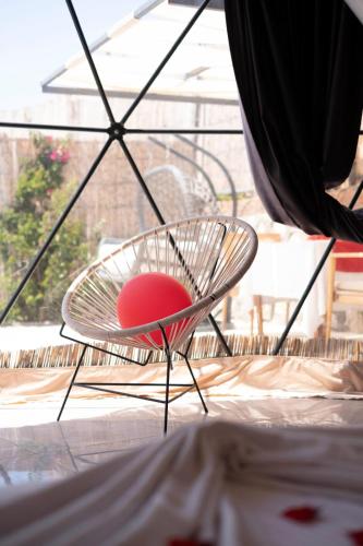 a chair with a red ball in it in front of a window at Kabak Freedom Deluxe Hotel in Faralya