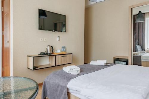 a hotel room with a bed and a glass table at City Heart Hotel in Tbilisi City