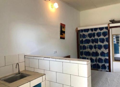 a kitchen with a sink and a counter top at OCEAN-SI Mansion in Kribi