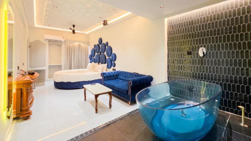 a bathroom with a large blue bowl in a room at Hotel Nova Bloom in Ahmedabad