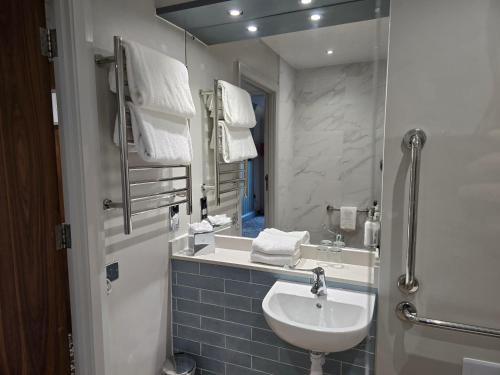 a bathroom with a sink and a mirror at Smiths At Gretna Green Hotel in Gretna Green