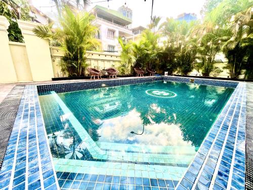 a swimming pool with blue tiles in a building at Sky Heritage Hotel in Phnom Penh