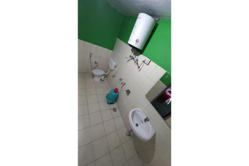 a bathroom with a urinal and a toilet at Thrillomania Kasol in Kasol