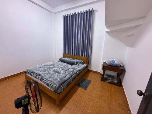 a small bedroom with a bed and a radiator at Mây's Villa in Da Lat