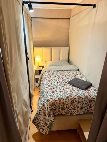 a small bedroom with a bed in a tent at Новый Хостел с Кабинками in Chişinău