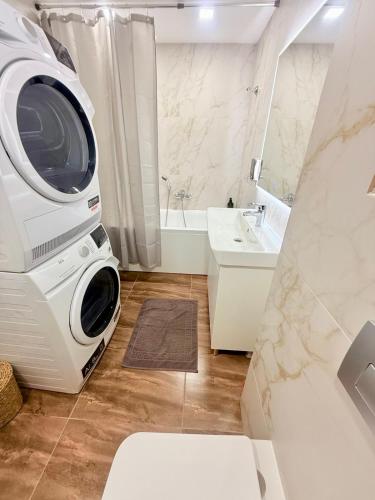 a bathroom with a large washing machine in it at Новый Хостел с Кабинками in Chişinău
