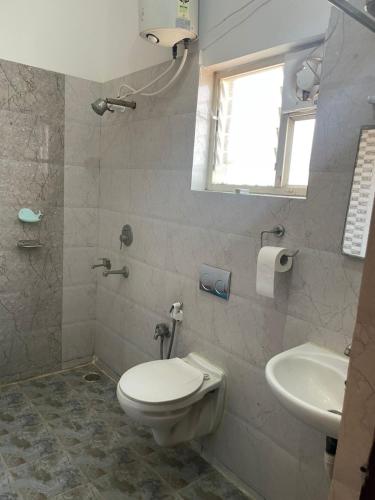 a bathroom with a toilet and a sink at hotel fortune city in Bangalore