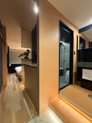 a bathroom with a sink and a shower in a room at Hatagoyorozu in Sasebo