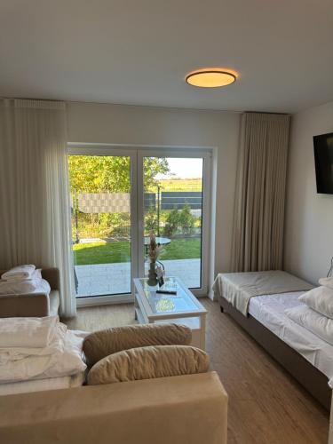 a hotel room with two beds and a window at Głębinów Apartamenty nad jeziorem nyskim in Głębinów