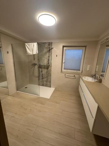 a bathroom with a shower and a sink at Głębinów Apartamenty nad jeziorem nyskim in Głębinów