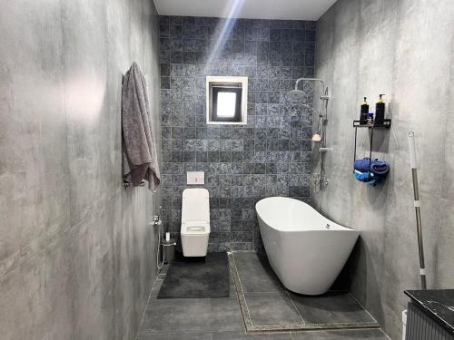 a bathroom with a tub and a toilet and a sink at Villa in Mayak in Baku