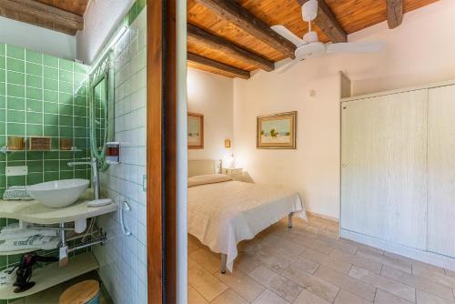 a bedroom with a bed and a sink in a room at Guest House Villa Verde - Short Term Room Rentals in Torre delle Stelle