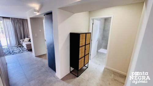 a room with a dresser in the middle of a room at O Palheiro in Biscoitos