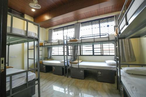 a group of bunk beds in a dorm room at Ananya Dorms in Hospet