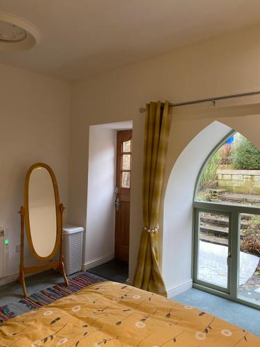 a bedroom with a bed and a window at The chapel in Machynlleth