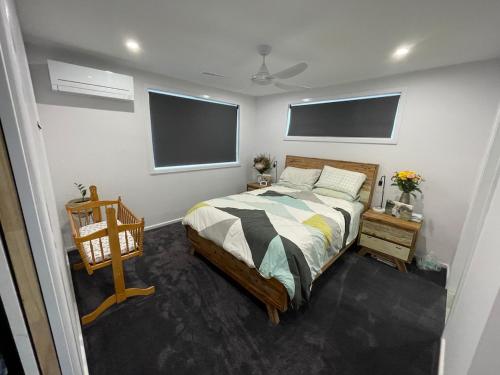 a bedroom with a bed and a flat screen tv at Poolside on the Plateau in Wollongbar