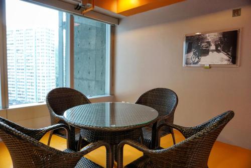 a table and chairs in a room with a window at Y Loft in Hong Kong