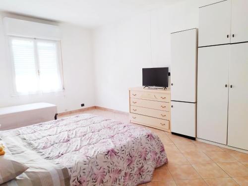 a bedroom with a bed and a tv on a dresser at Levico Centrale Apartment in Levico Terme