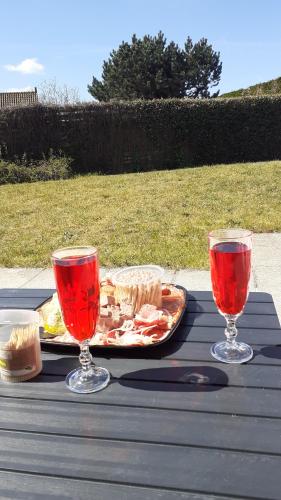 a table with a plate of food and two wine glasses at a l'aise aan zee in Koksijde