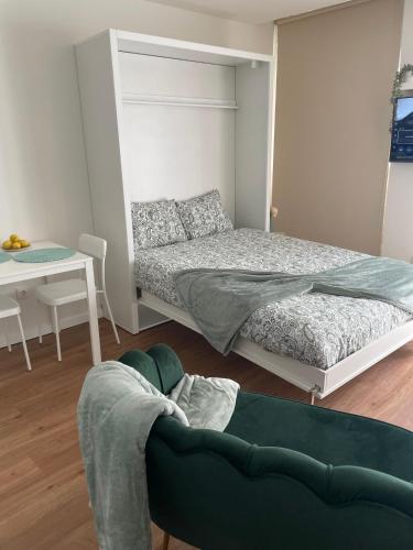 a bedroom with a bed and a couch and a table at Casa da Avo Ilda - Near the Sea in Matosinhos