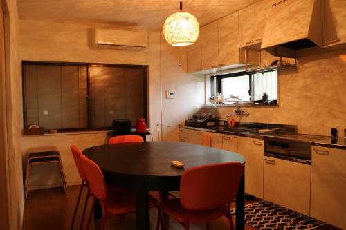 a kitchen with a table and red chairs in it at Bob's house - Vacation STAY 42876v in Kameoka