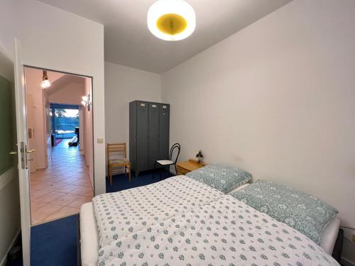 a bedroom with a bed and a door to a hallway at Große Terrassenwohnung mit Seeblick in Stechlin