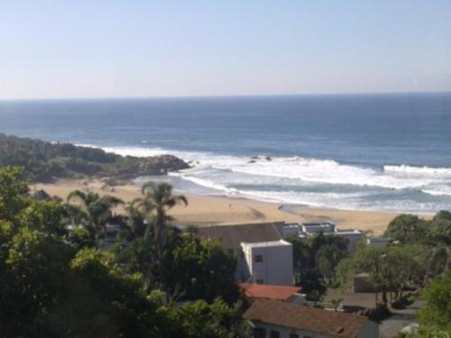 a view of a beach and the ocean at Providence 79 in Uvongo Beach