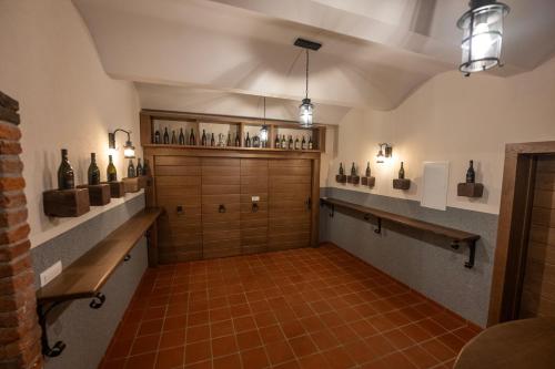 a large room with a large door and shelves of wine bottles at Anivina - B&B in Ivanjkovci