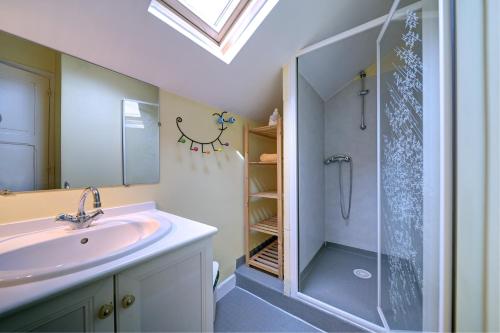 a bathroom with a sink and a shower at Luchon Maison Flor in Luchon