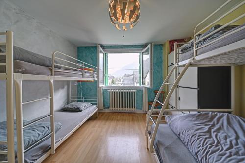 a room with three bunk beds and a window at Luchon Maison Flor in Luchon