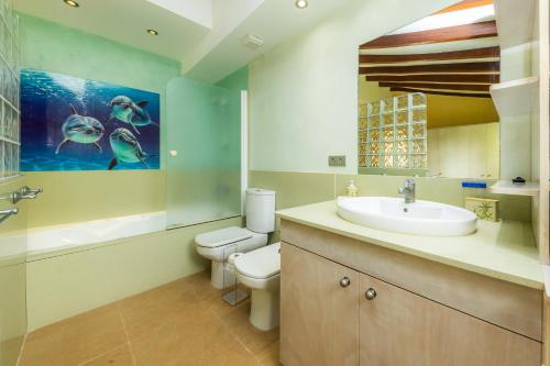 a bathroom with a sink and a toilet and a tub at Can Magraner in Port de Pollensa