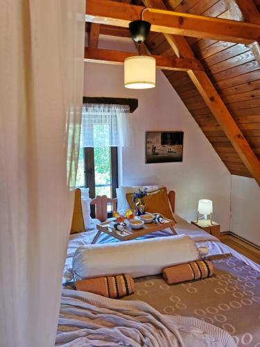 a bedroom with two beds and a table at Greenwood Cottage house for rent near Zagreb in Pisarovina