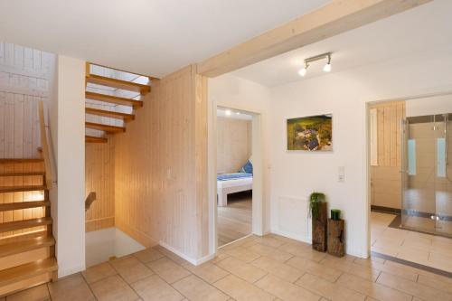 an empty room with a staircase and a bedroom at Ferienhaus Wasserfall in Bestwig