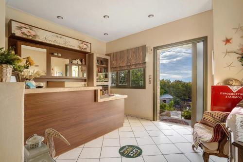 a kitchen with a counter and a living room at Nontas Homes 34 in Kalamitsi