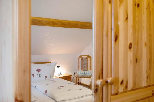 a small bedroom with a bed and a mirror at Ferienwohnungen Carstensen in Nordstrand