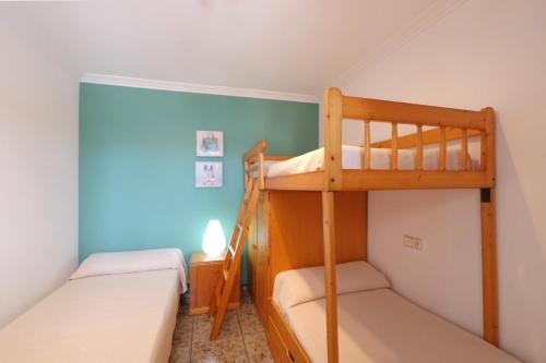 two bunk beds in a room with blue walls at Ca Na Cati in Muro