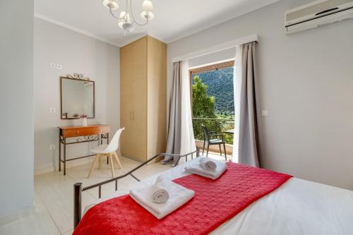 a bedroom with a bed and a desk and a window at Villa prolithia 2 in Vlikhón