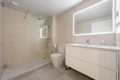 a bathroom with a sink and a toilet and a shower at Costa Dorada Perle in Calafell