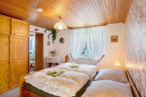 a bedroom with two beds and a window at Haus Sielblick in Wangerland