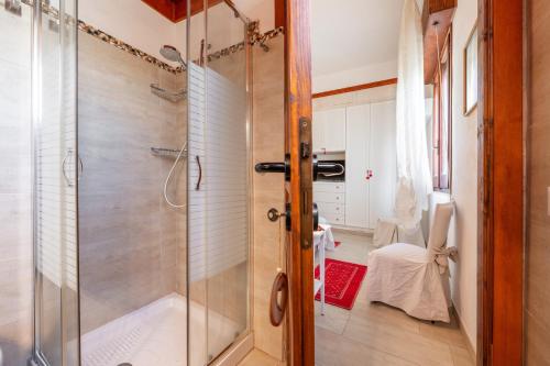 a shower with a glass door in a bathroom at Villa Rita in Flumini di Quartu