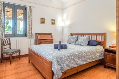 a bedroom with a bed and a chair at Mas Vinyoles 1 in Montnegre