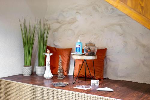 a table with a bottle of soap and plants on it at Stadtzimmer Im Entenmoos in Bad Waldsee