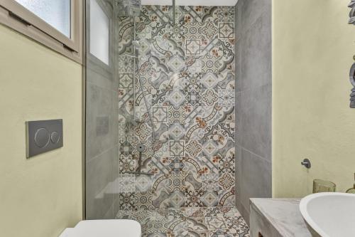 a bathroom with a toilet and a tile shower at Natura Oliva House in Alikanas