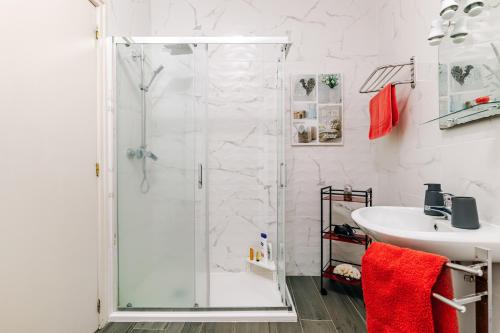 a bathroom with a shower and a sink at Garden View Apartment in Horta